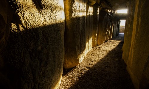 Sun beam shining through the roof box at Newgrange at the Solstice