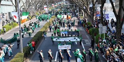 crowds marching in St Patrick's Day parade in Tokyo