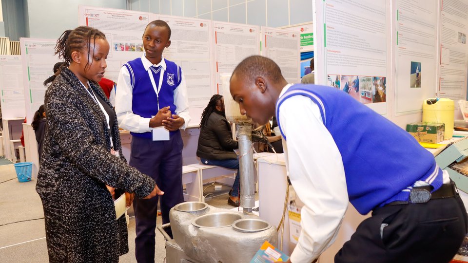 Students showing their project at a fair