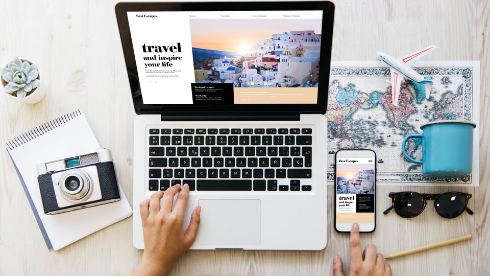 An overhead view of a laptop where someone is planning travel