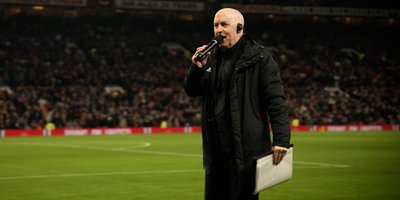 Alan Keegan on the pitch with a microphone