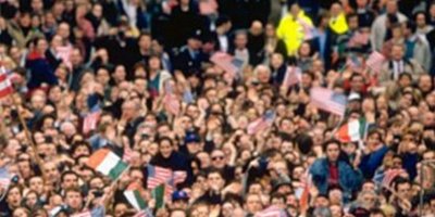 crowds waving Irish and American flags