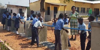 Children washing their hands at outdoor wash stations. Copyright Built It International.