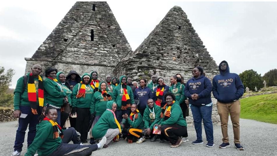 Ugandan teachers outside a medieval monastery