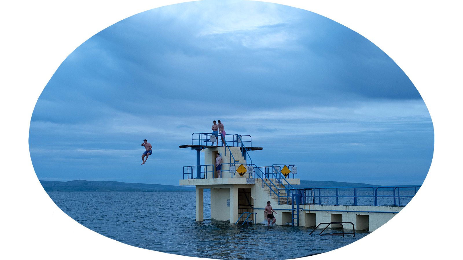People jumping off the Blackrock diving tower in Galway