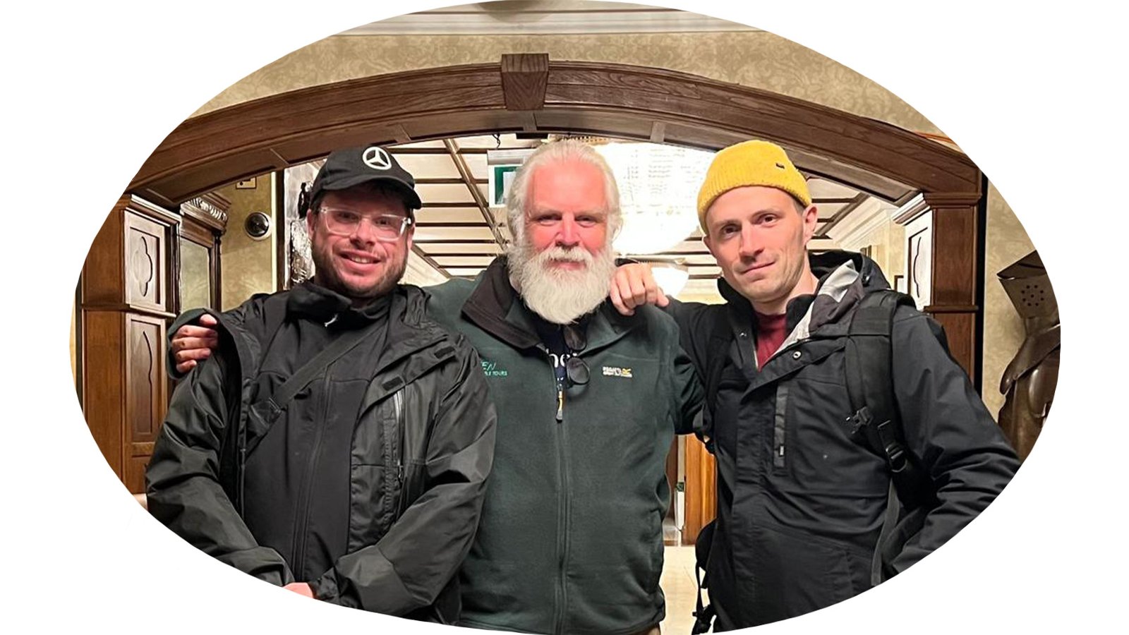 Three men posing for a group photo, artist The Blind, fixer Mick and videographer Olive Yeah