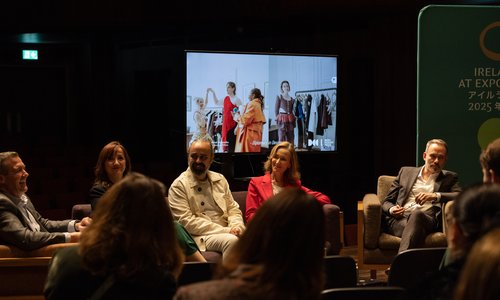 Panel sitting infront of a screen with rotating photos