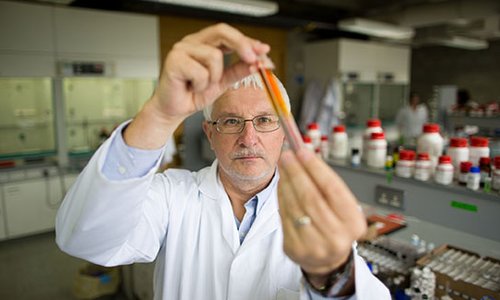 man in coat in a lab