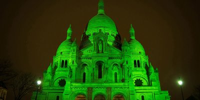 The Sacre Coeur lit up in green lighting.