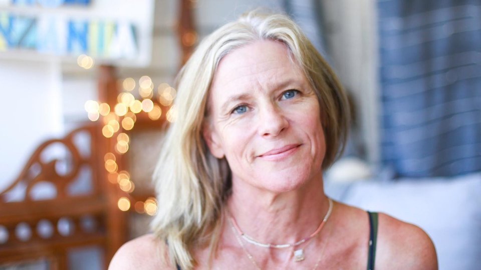 Woman standing infront of fabrics
