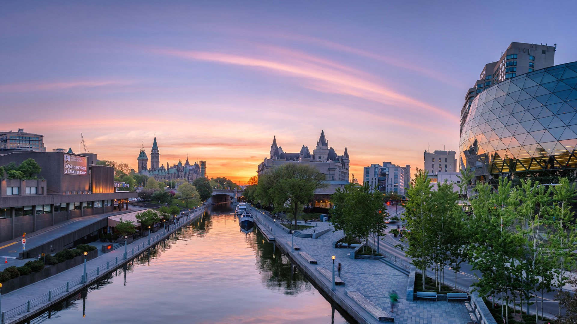 View of Toronto's skyline from the water at sunrise.