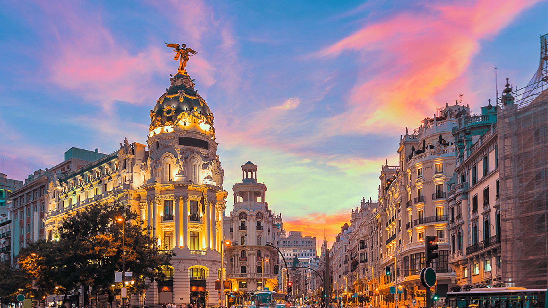 View of Madrid's Grand Via main street at sunset.