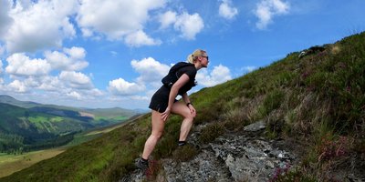 Ivana Kolaric climbing a mountain on a sunny day