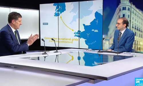 two men sitting side on talking, with interactive map of france and ireland connecting the two countries