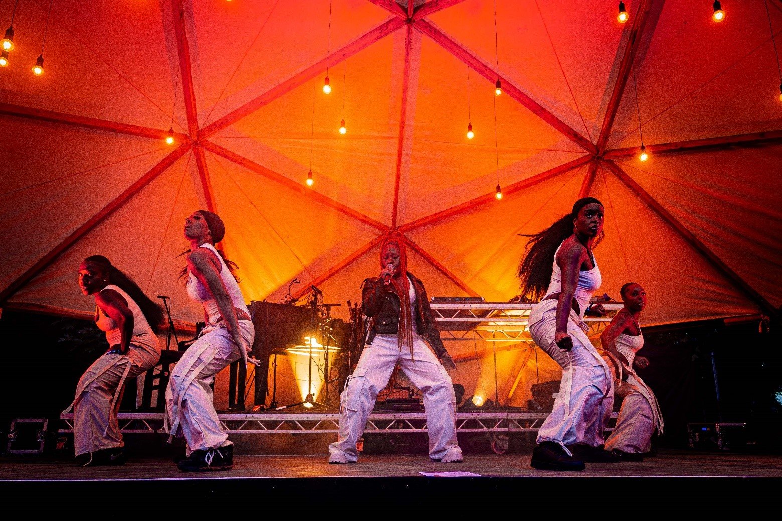 Girl on stage with backup dancers