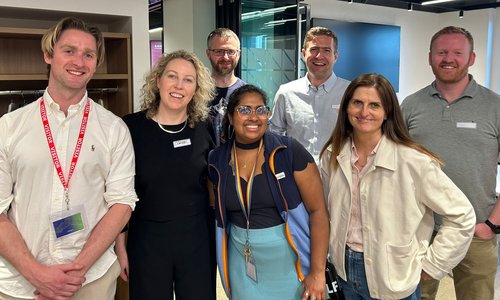 Group of people standing on a golf course
