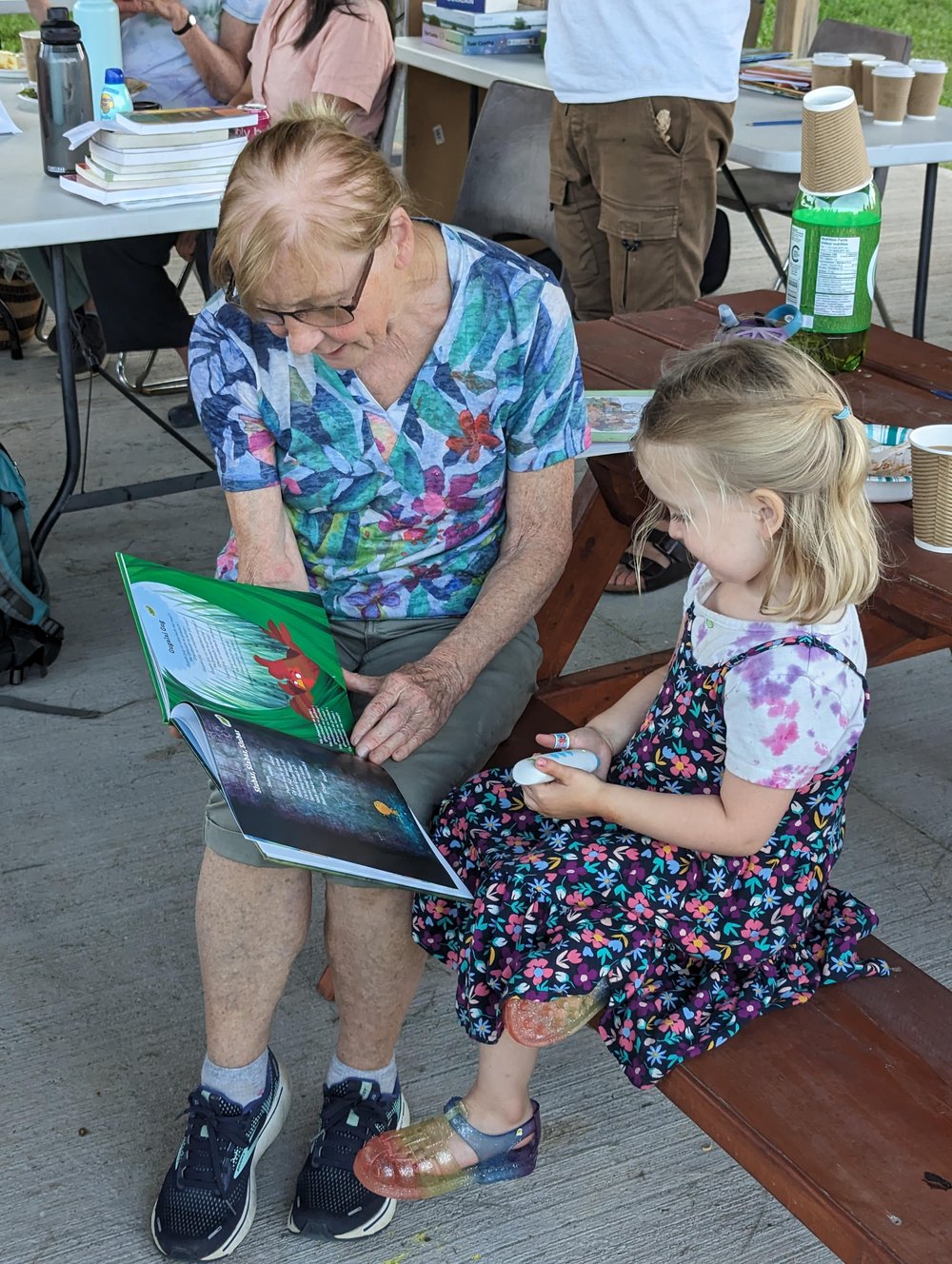 A woman reading a book to a child