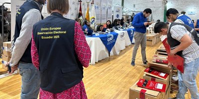 Election observers in EU-branded vests in gym / count centre in Equador