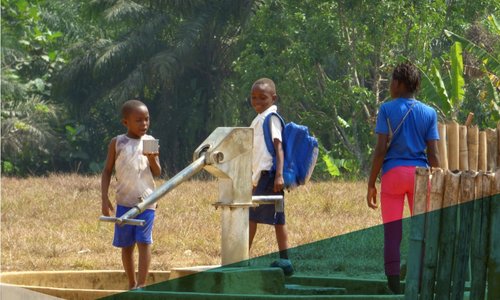 Three young boys getting water from a water pump.