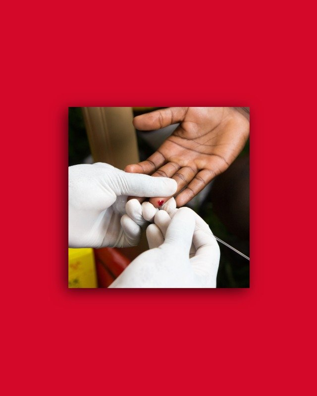 Person wearing medical gloves performing finger prick test