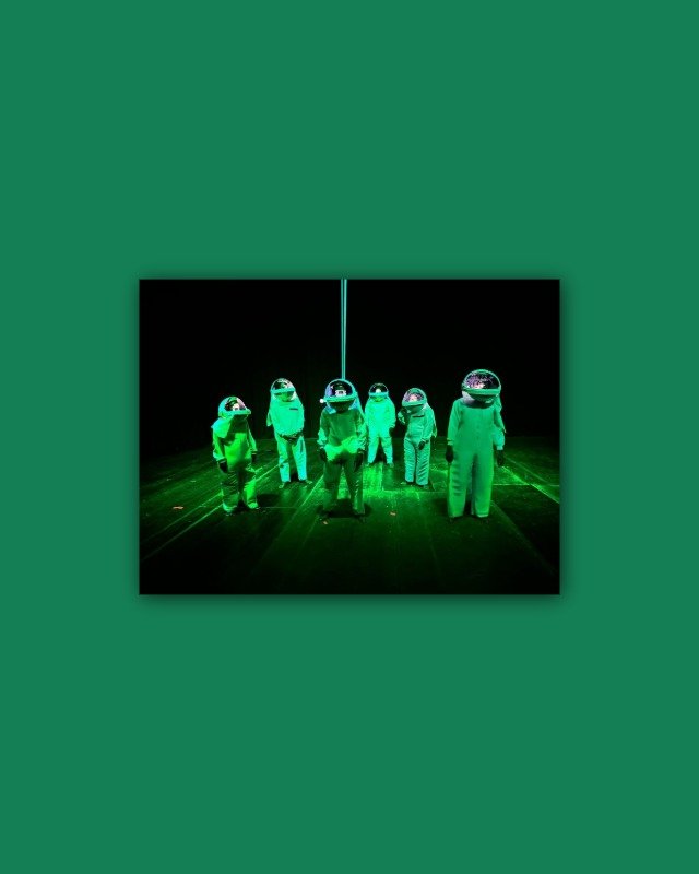 People wearing illuminated green space suits