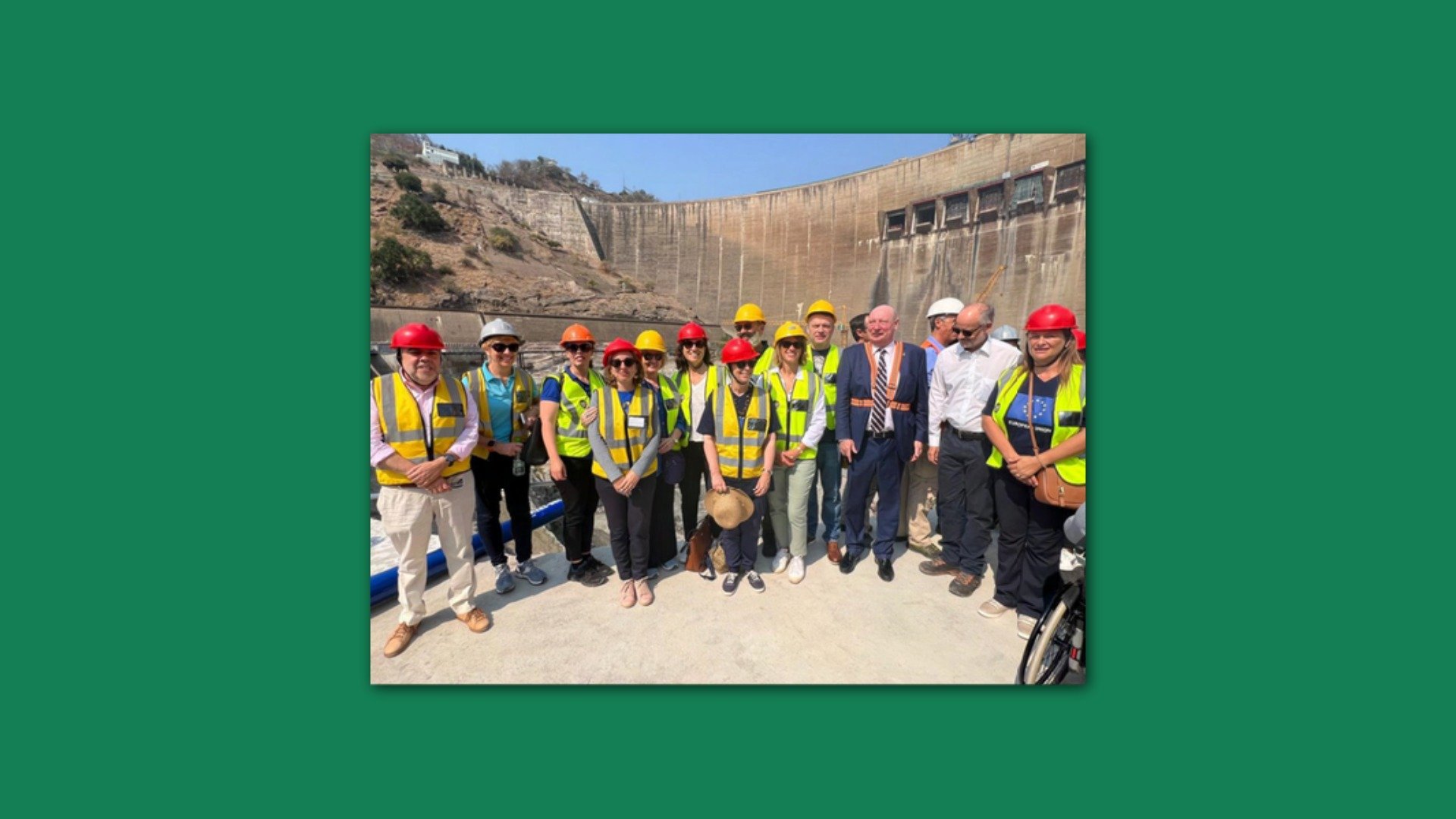 a group of people in hi-vis vests and hard hats