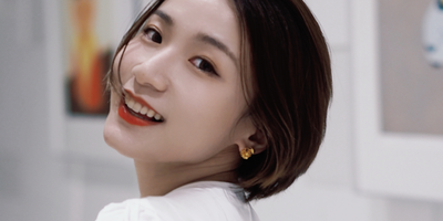 A woman looks over her shoulder toward the camera