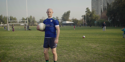 Paddy Coary stood on a pitch with a football