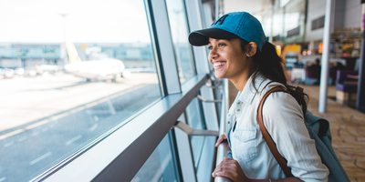 Woman looking out the window at the airport